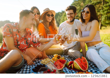 Happy groop of friend resting in nature in picnic. People, lifestyle, relaxation, vacations concept. 125621861