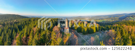 Stepanka Lookout Tower stands tall amidst vibrant spring greenery in Korenov. Early morning light illuminates the surrounding Jizera Mountains, creating a serene atmosphere perfect for nature lovers. Stepanka Lookout Tower stands tall amidst vibrant spring greenery in Korenov. Early morning light illuminates the surrounding Jizera Mountains, creating a serene atmosphere perfect for nature lovers. 125622248