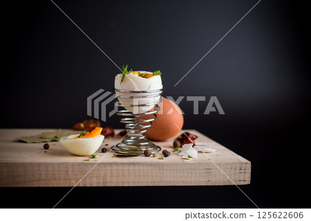 morning soft boiled egg in egg cup isolated on black background 125622606