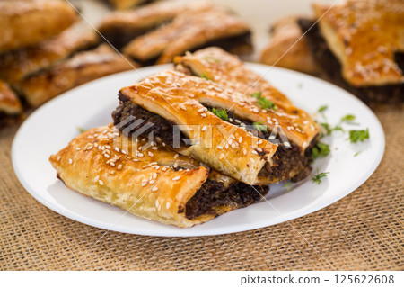 Golden puff pastries with mushroom filling and sesame seeds Golden puff pastries with mushroom filling and sesame seeds 125622608