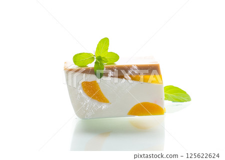 milk fruit jelly with pieces of fruit inside on white background milk fruit jelly with pieces of fruit inside on white background 125622624