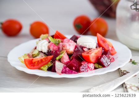 Healthy salad with mozzarella and beetroot, served on a wooden surface Healthy salad with mozzarella and beetroot, served on a wooden surface 125622639