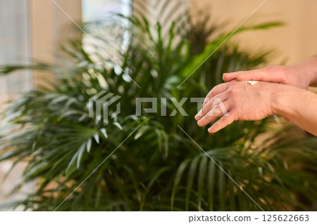 A gloved hand prepares to perform a care procedure safely and professionally in healthcare 125622663