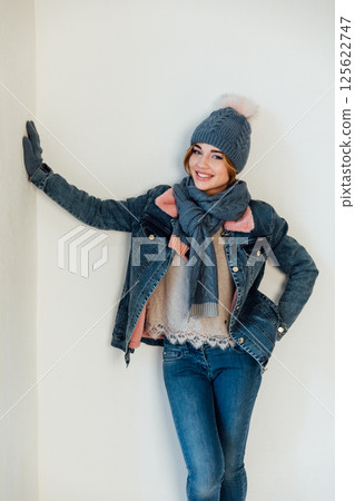 Beautiful woman in winter denim clothes and hat on white background Beautiful woman in winter denim clothes and hat on white background 125622747