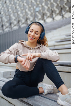Strong woman doing exercises outdoors in the morning. Active life, healthy lifestyle. Strong woman doing exercises outdoors in the morning. Active life, healthy lifestyle. 125622763