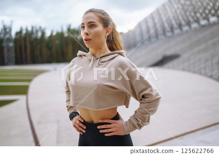 Strong woman doing exercises outdoors in the morning. Active life, healthy lifestyle. Strong woman doing exercises outdoors in the morning. Active life, healthy lifestyle. 125622766