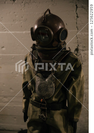 A diver stands in a diving suit before diving A diver stands in a diving suit before diving 125622959