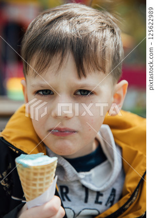 boy eating delicious ice cream boy eating delicious ice cream 125622989