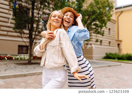 Two beautiful women having fun outdoors. Fun, weekend concept. Active lifestyle. Two beautiful women having fun outdoors. Fun, weekend concept. Active lifestyle. 125623109