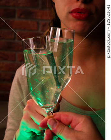 Woman close up with Sparkling Green Cocktail in Focus 125623641