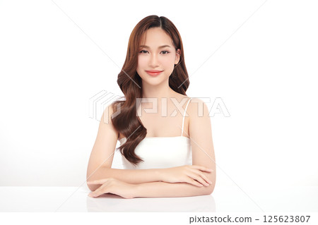 A beautiful young Asian woman with clean, fresh skin against a white background. Skincare, facial treatment, cosmetology, beauty, and spa. An elegant portrait of an Asian woman. 125623807