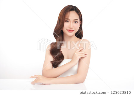 A beautiful young Asian woman with clean, fresh skin against a white background. Skincare, facial treatment, cosmetology, beauty, and spa. An elegant portrait of an Asian woman. 125623810