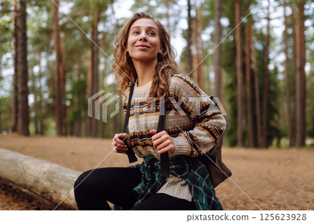 Tourist woman hiking alone in natural forest. Active lifestyle. People in forest. Nature, travel Tourist woman hiking alone in natural forest. Active lifestyle. People in forest. Nature, travel 125623928