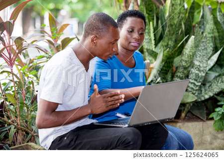 portrait of young students sitting with laptop. portrait of young students sitting with laptop. 125624065