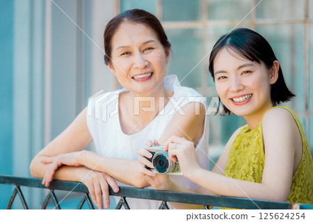 Women taking photos on a girls trip Resort travel image 125624254