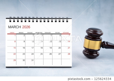 March 2026 desk calendar with judge's gavel on worktable. March 2026 desk calendar with judge's gavel on worktable. 125624334