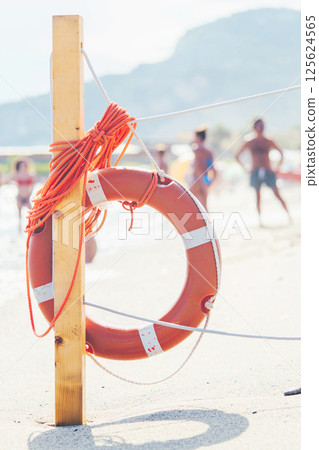 Life saver rescue ring with rope on the beach in case of emergency. Life saving lifeguard buoy 125624565