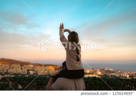 Father and daughter bonding with sunset view over the Costa del Sol 125624697
