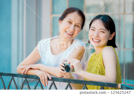 Women taking photos on a girls trip Resort travel image 125625247