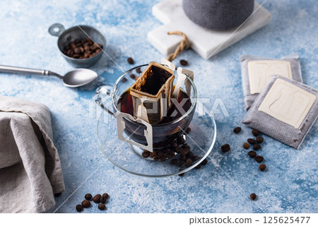 Freshly brewed drip coffee in glass cup Freshly brewed drip coffee in glass cup 125625477