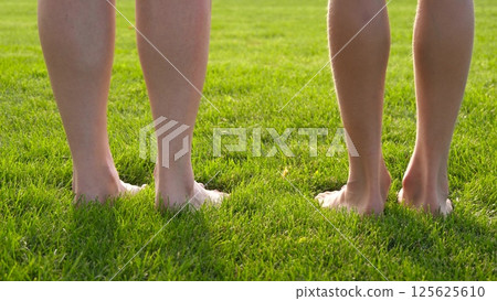 Barefoot walking, summer grass, barefoot relaxation in nature. Soft green lawn, feet touch, outdoor wellness. Bare feet connect with summer, park recreation, healthy lifestyle, peaceful garden, Barefoot walking, summer grass, barefoot relaxation in nature. Soft green lawn, feet touch, outdoor wellness. Bare feet connect with summer, park recreation, healthy lifestyle, peaceful garden, 125625610