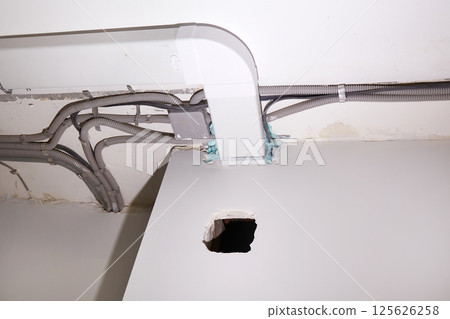 Installation of electrical wiring and ventilation on the ceiling. Installation of electrical wiring and ventilation on the ceiling. 125626258