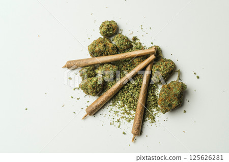 Close up of marijuana joint and buds on white background. 125626281