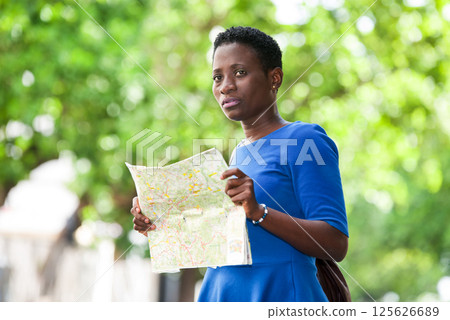 portrait of young woman with map. 125626689