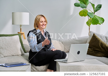 Business middle aged woman having video conference chat using laptop Business middle aged woman having video conference chat using laptop 125627101