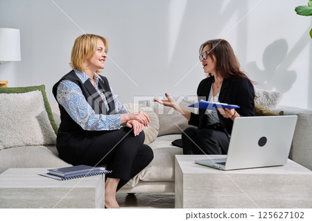 Mental therapy session, middle aged woman patient talking to professional psychologist Mental therapy session, middle aged woman patient talking to professional psychologist 125627102