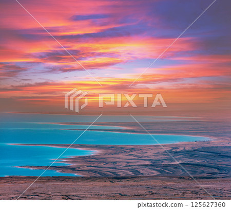 Seascape in the morning with a beautiful dramatic sky. Colorful sunrise over the Dead Sea 125627360