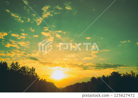 Rural landscape in the evening. Sunset over the forest 125627472