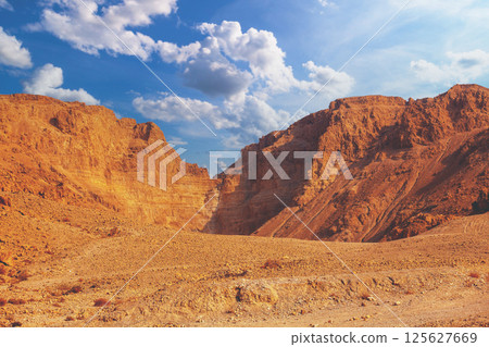 Mountain desert. Sandstone mountains against the blue sky Mountain desert. Sandstone mountains against the blue sky 125627669