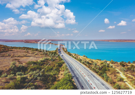View from above of highway and rod bridge over Khadzhibey Estuary. Ukraine 125627719