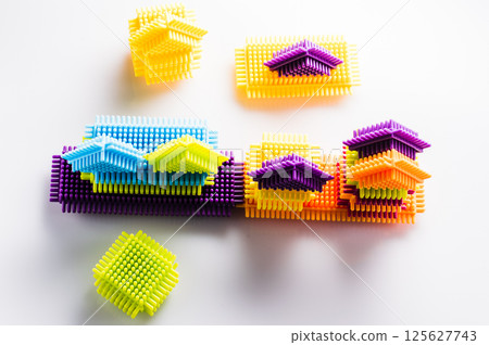 A children's construction set in the form of multicolored blocks stimulates creativity and imagination. The colorful elements of the play-constructor blend harmoniously with each other. 125627743