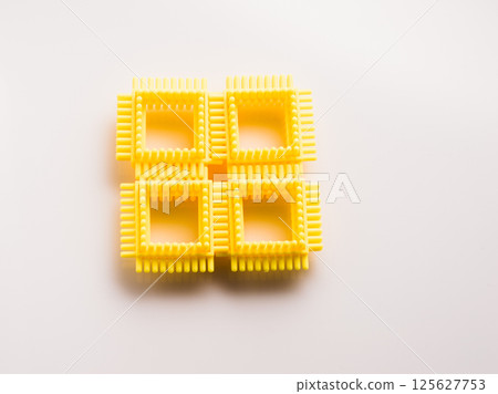 Yellow parts of a children's construction set. Puzzle for children, Yellow parts of a children's construction set. Puzzle for children, 125627753