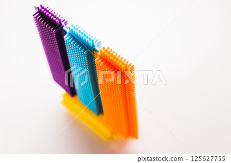 The children's construction set is assembled into random models with no defined shape. The elements of the construction toy display a variety of colors and textures. 125627755