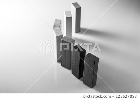 Black and white photo of children's developmental blocks. Wooden pieces of different lengths lie side by side. Colorful sticks are used in Montessori learning methods. Black and white photo of children's developmental blocks. Wooden pieces of different lengths lie side by side. Colorful sticks are used in Montessori learning methods. 125627858