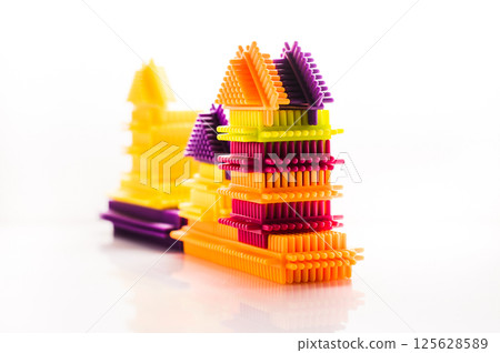 The children's construction set includes multicolored elements that spark interest and encourage play. The vibrant colors combined with the white background create a sense of lightness.  125628589