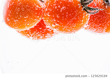 A black-and-white photo showing a glass with a long stem containing a carbonated drink. A black-and-white photo showing a glass with a long stem containing a carbonated drink. 125629184