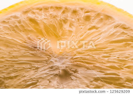 A beautiful slice of lemon. The texture of the lemon is beautifully visible. A beautiful slice of lemon. The texture of the lemon is beautifully visible. 125629209