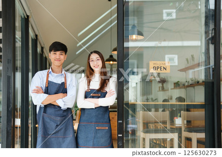 Small business owners standing together inside cozy coffee shop 125630273