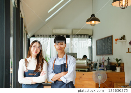 Small business owners standing together inside cozy coffee shop 125630275