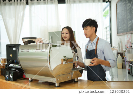 Barista and waiter working in a bar cafeteria shop 125630291