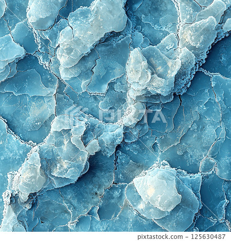 Intricate aerial view of a frozen landscape with beautiful blue and white patterns. 125630487