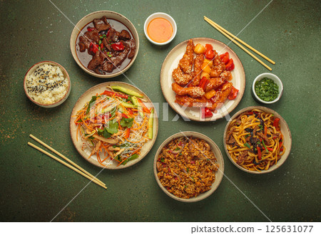 Variety of Chinese food dishes top view on table with chopsticks, rustic green background, cuisine of China Variety of Chinese food dishes top view on table with chopsticks, rustic green background, cuisine of China 125631077