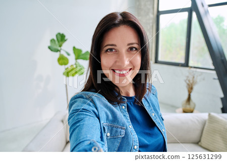 Selfie portrait happy beautiful woman in home interior Selfie portrait happy beautiful woman in home interior 125631299