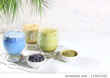Assortment of colorful Japanese tea latte with milk, green, blue, pink moon milk, golden milk. Fashionable healthy drink has anti-inflammatory properties, promotes weight loss, selective focus Assortment of colorful Japanese tea latte with milk, green, blue, pink moon milk, golden milk. Fashionable healthy drink has anti-inflammatory properties, promotes weight loss, selective focus 125631381