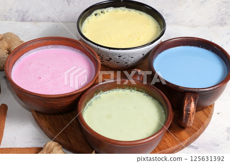 Assortment of colorful Japanese tea latte, golden turmeric, matcha, blue, pink moon milk. Anti-inflammatory, immunity-boosting, alternative medicine, selective focus 125631392