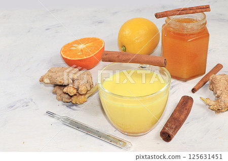 Golden turmeric latte with ginger root, cinnamon sticks, turmeric, spices for Ayurvedic medicine. The concept of alternative medicine, a means to increase immunity in a pandemic, coronovirus 125631451